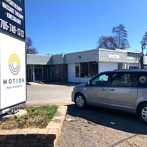 Peterborough storefront with Motion van and street signage