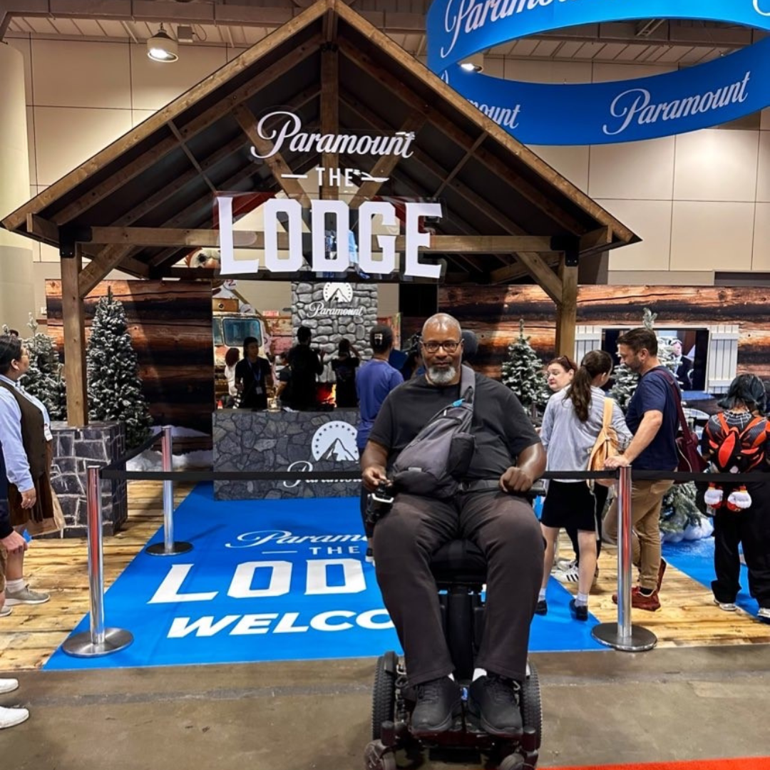 Garrick in front of the Paramount Lodge display.