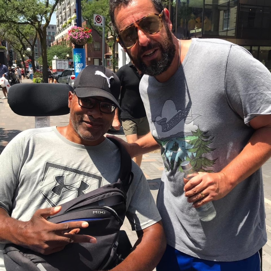 Garrick next to Adam Sandler.