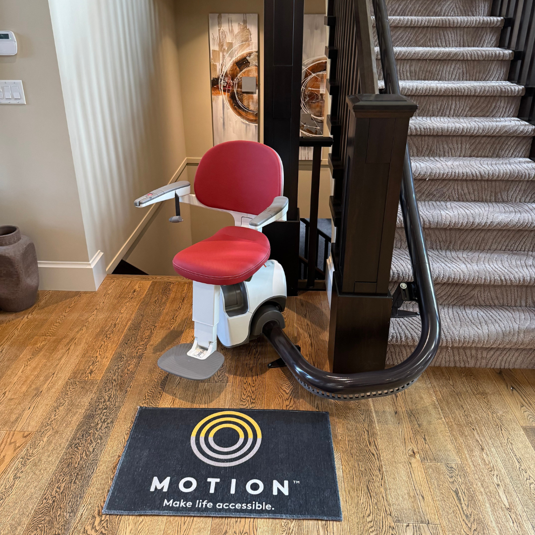 Red curved stairlift with Motion logo.