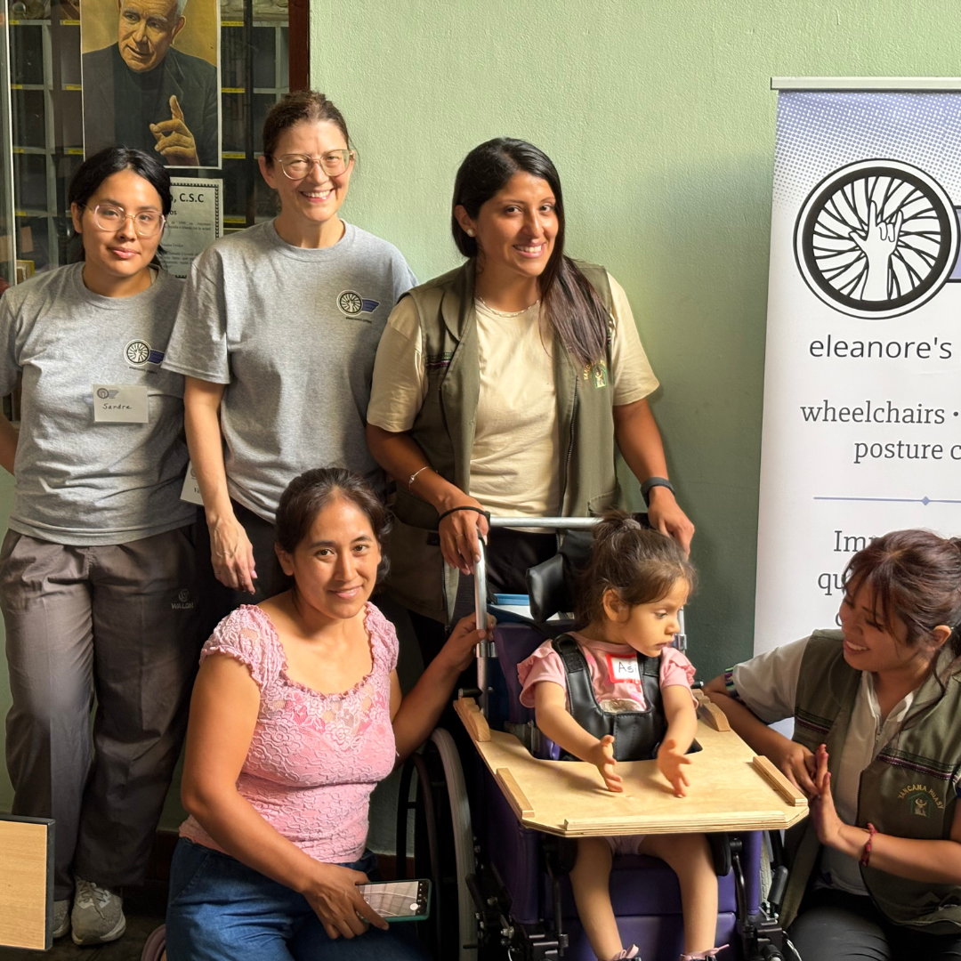Vickey posing with families part of the Eleanore Project.