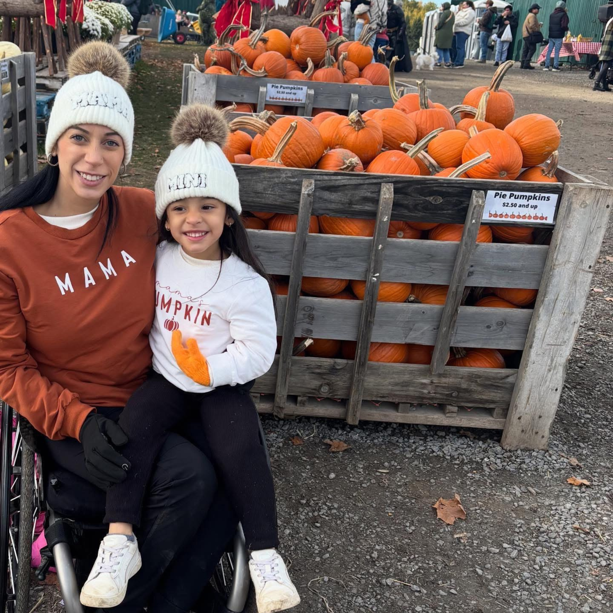 Alicia - Client Ambassador in her wheelchair with her daughter.